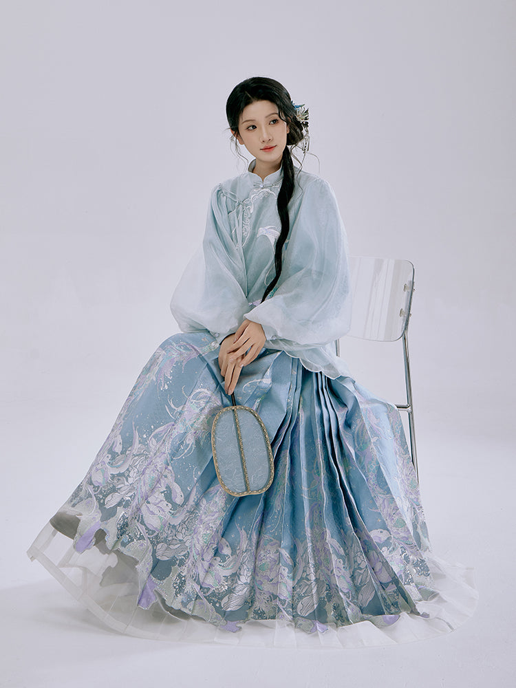 Model wearing Ethereal Koi Hanfu Set in celadon blue, featuring traditional Chinese Mamian skirt with lotus and koi fish design inspired by Ru kiln porcelain