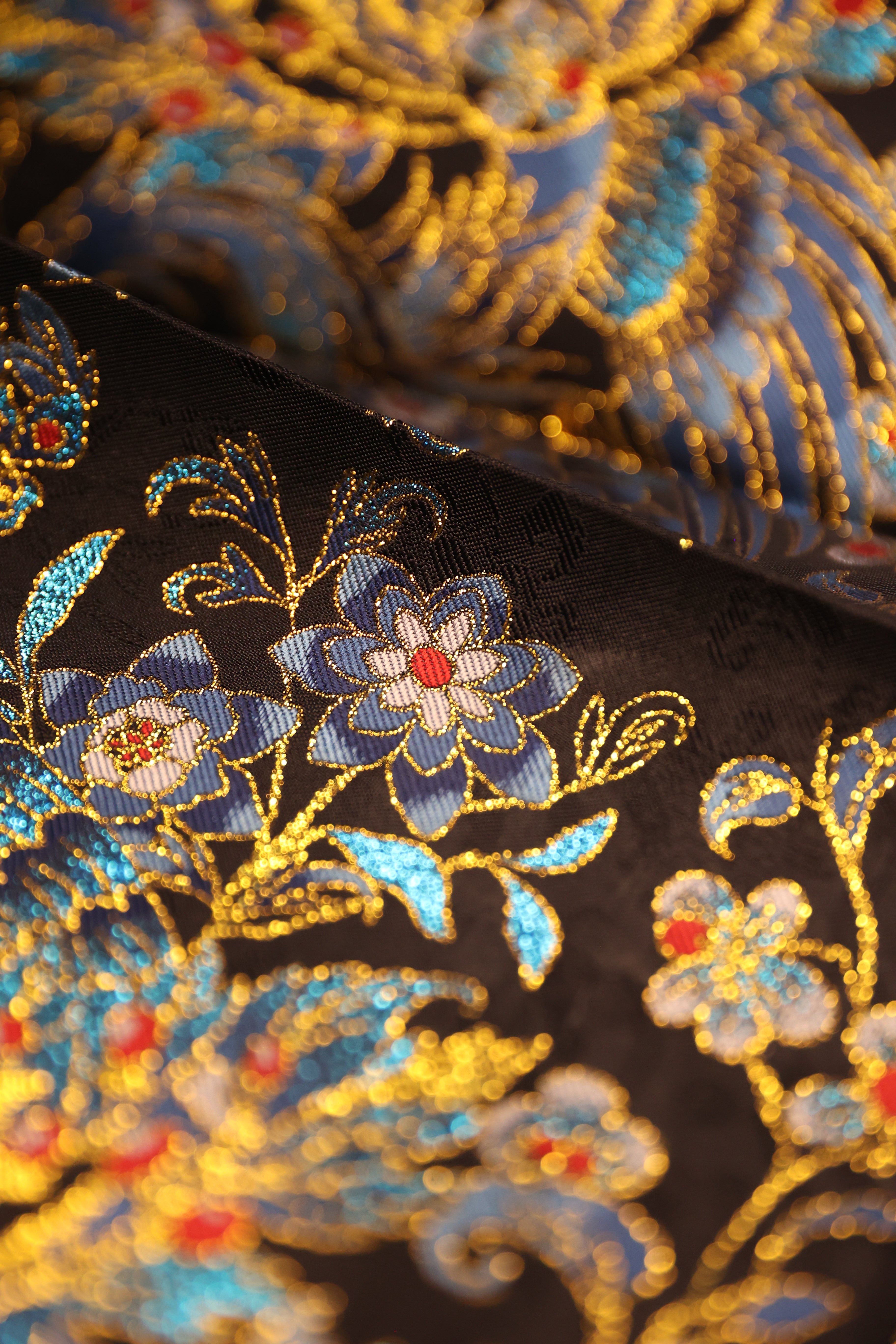 Detailed view of gemstone golden flower embroidery on Cui Yu Mamian Skirt, representing ever-blooming lotus and auspicious fortune in traditional Chinese hanfu design