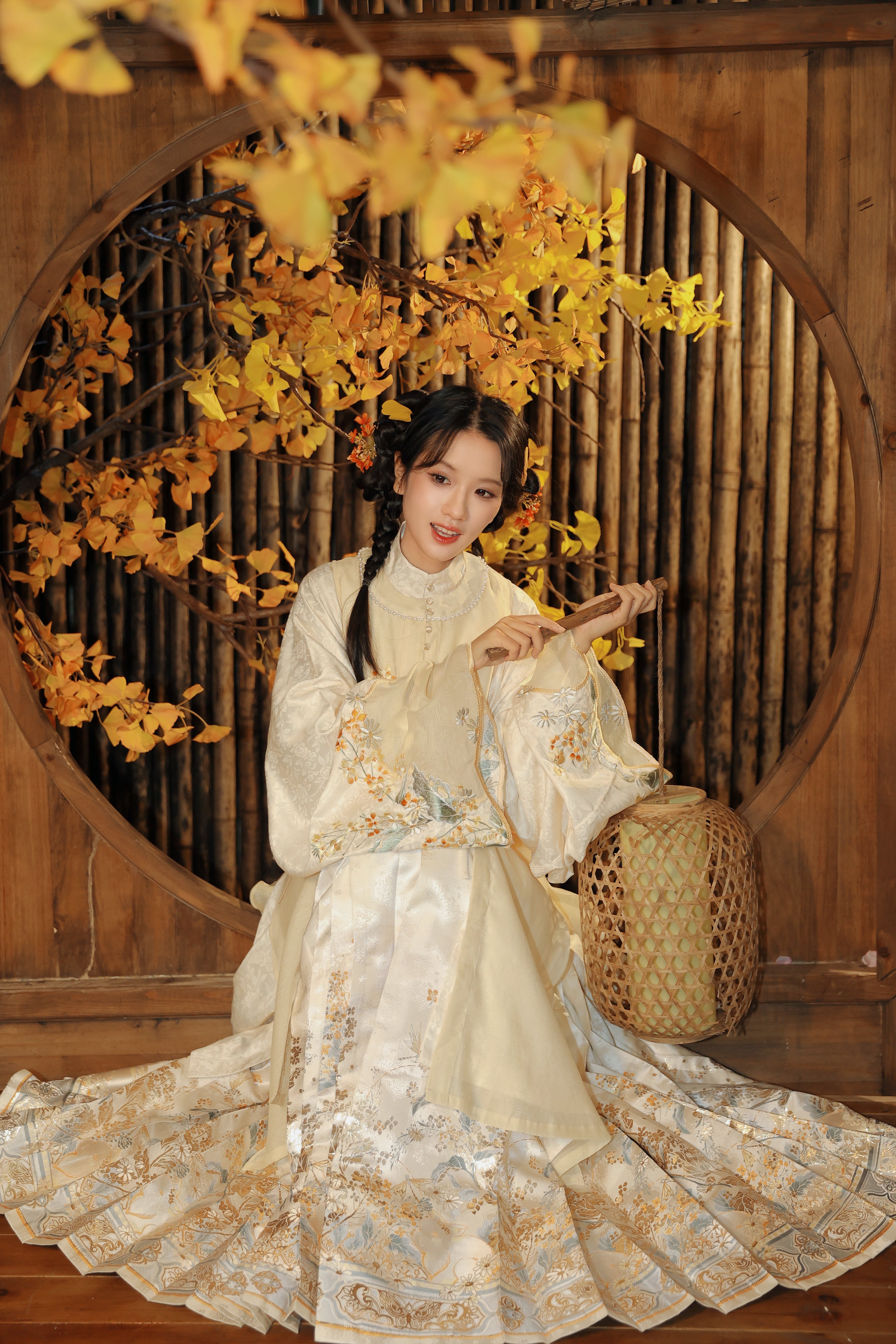 Model demonstrating how the cream-colored Mamian skirt with detailed embroidery pairs with mandarin collar shirt for a complete traditional Chinese outfit.