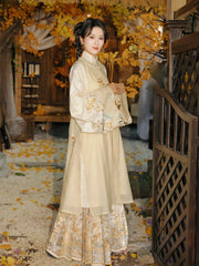 Front view of traditional Chinese Mamian skirt in soft cream color with intricate gold thread bunny embroidery, showcasing rare double-warp weaving technique and masterful embroidery craftsmanship