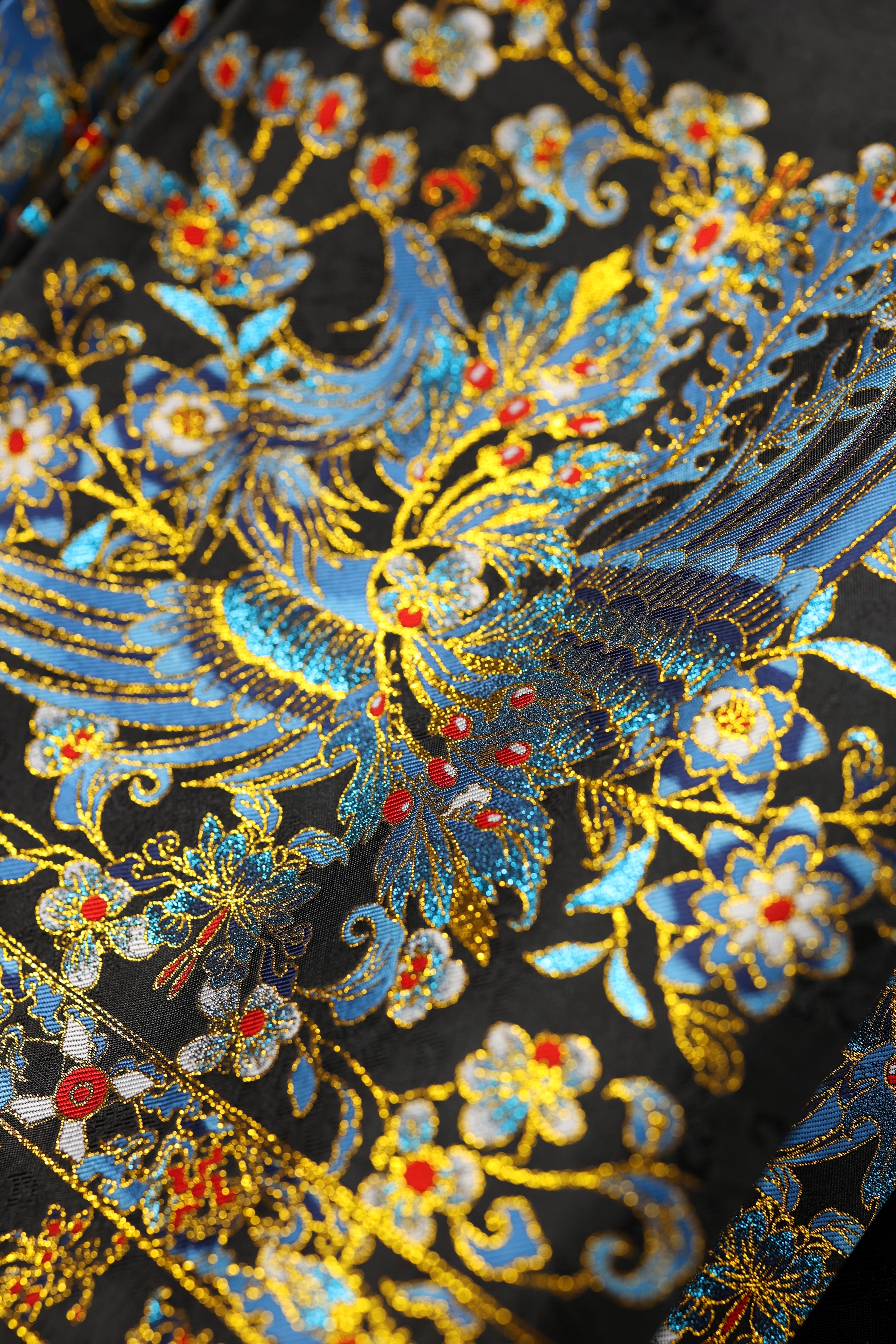 Intricate Azure Phoenix totem detail on traditional Chinese hanfu Mamian Skirt, showcasing the mythical divine bird of the Queen Mother of the West with surrounding jewelry embroidery