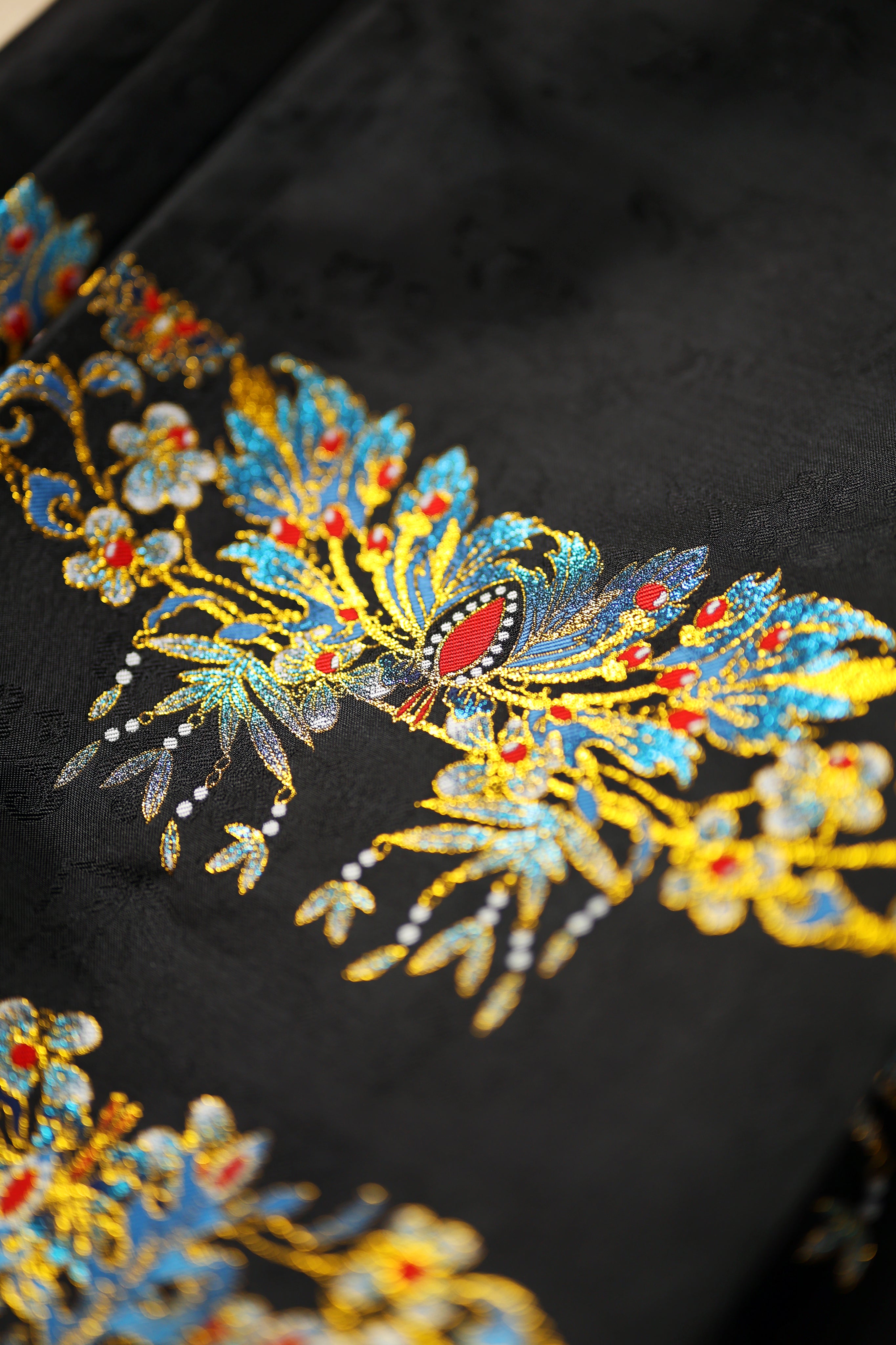 Craftsmanship detail of Cui Yu traditional Chinese Mamian Skirt showing the transition between royal phoenix crown pattern and azure phoenix totem, highlighting authentic Song dynasty hanfu techniques with modern application.